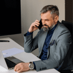 A member of a business selling team is cold calling an ideal business-for-sale buyer.