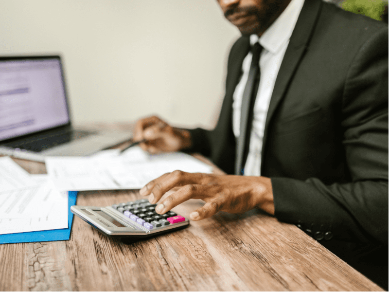 An accountant calculates possible taxes for a business sale.