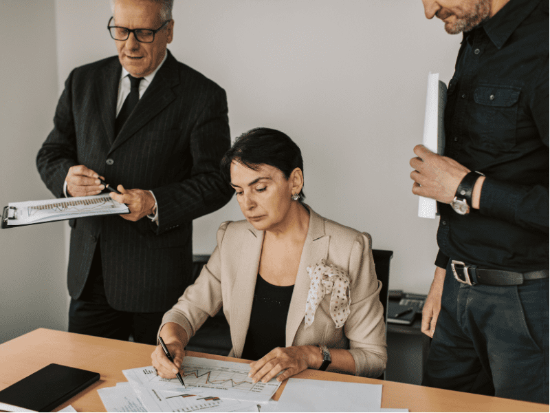 A business owner with experts preparing for a business sale.