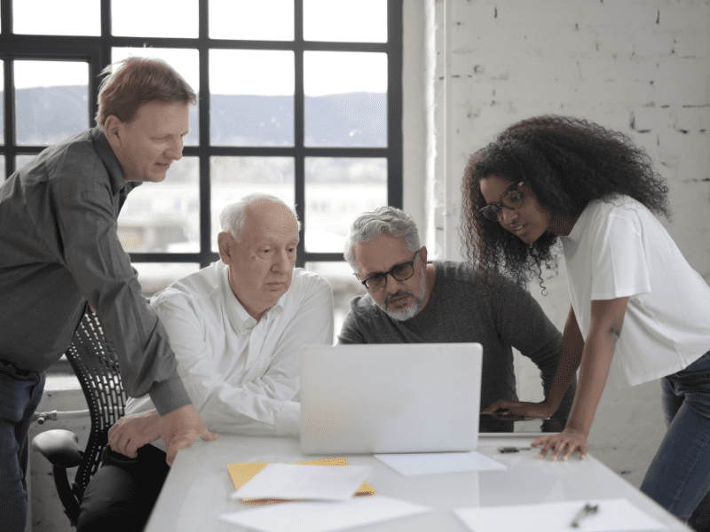 Entrepreneur and advisors talking about the key steps in business selling.