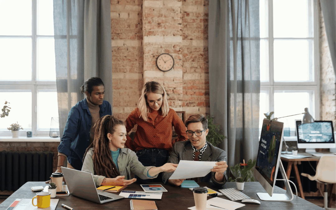 Team of business experts strategizing on how to market a business for sale effectively.